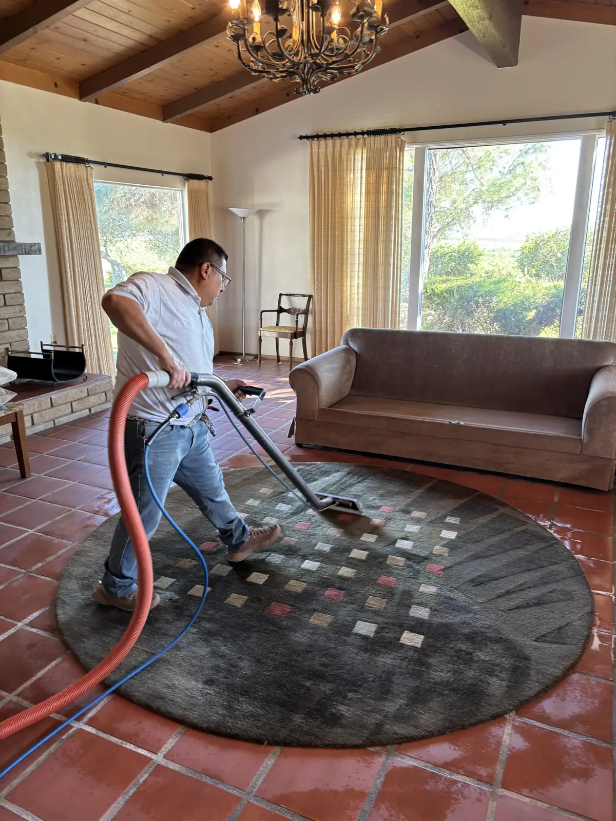 Hot water extraction carpet cleaning in a living room