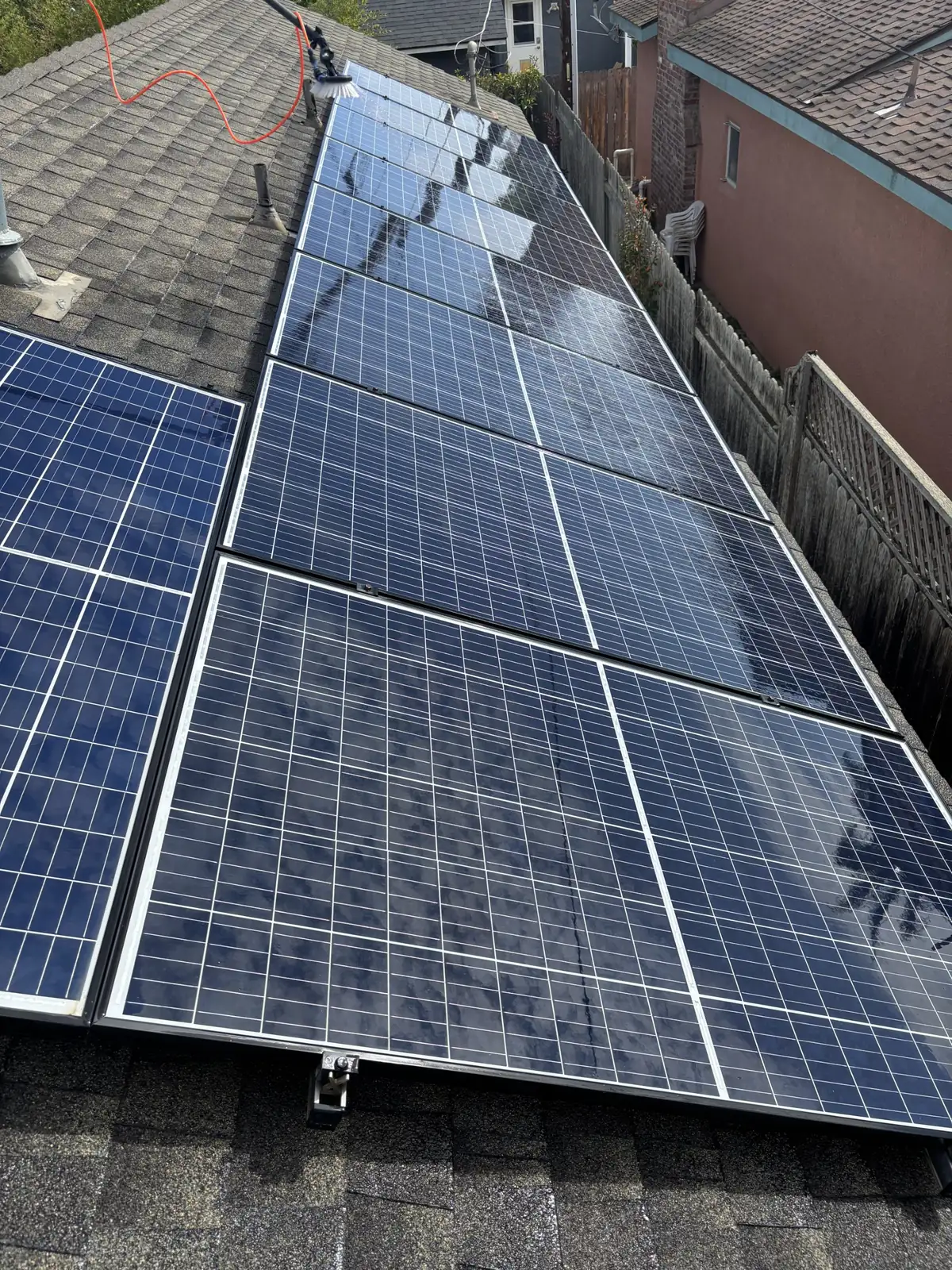 Row of clean rooftop solar panels after washing