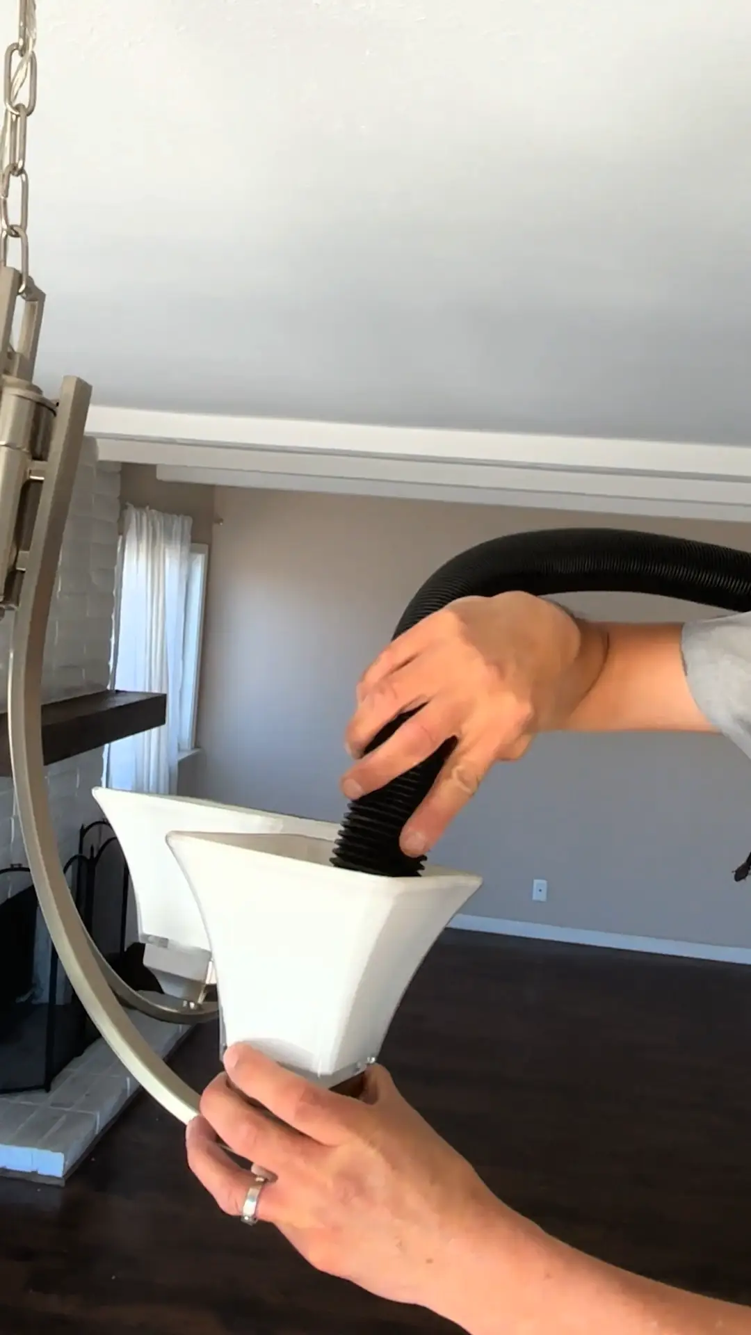 Vacuuming dust from a pendant light shade