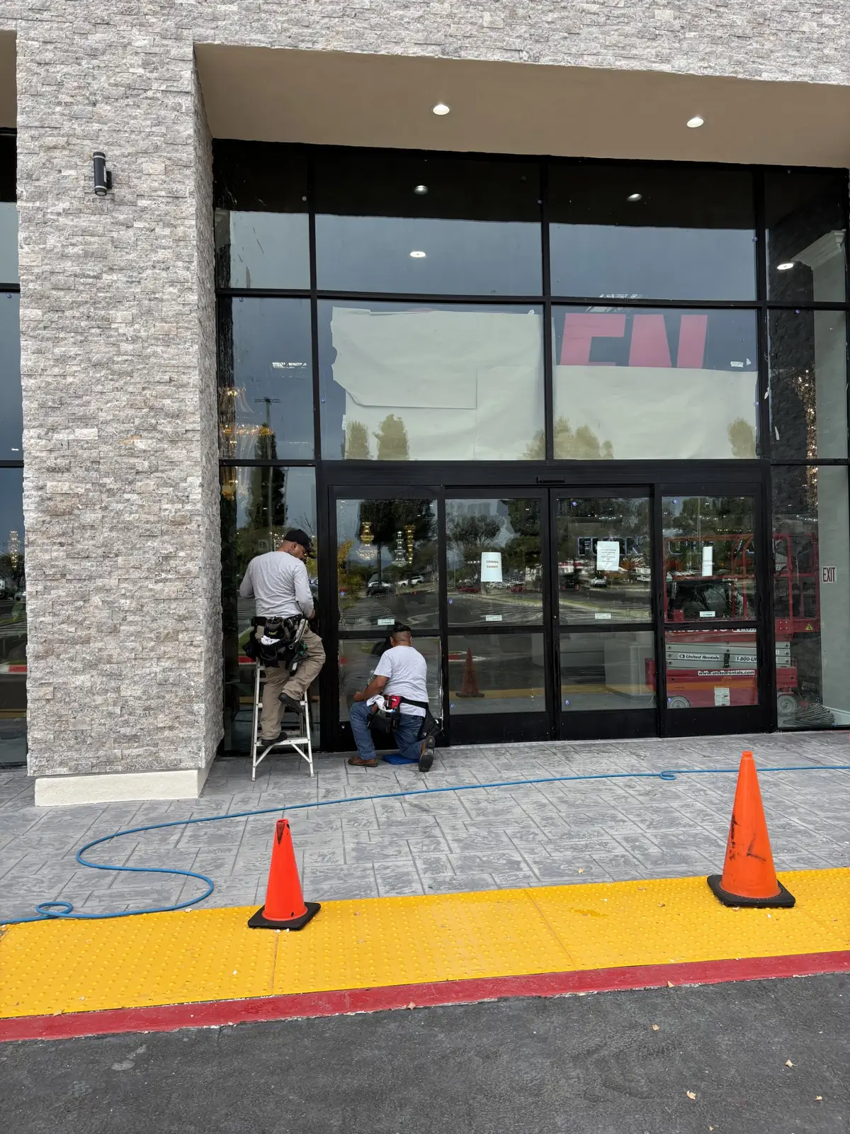 Removing construction residue from storefront glass