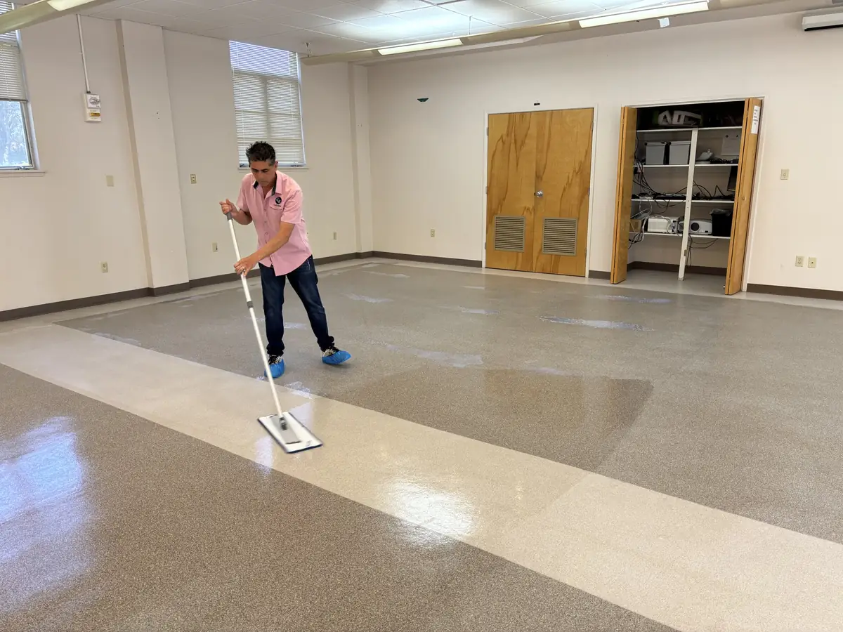 Spreading floor finish with a flat mop